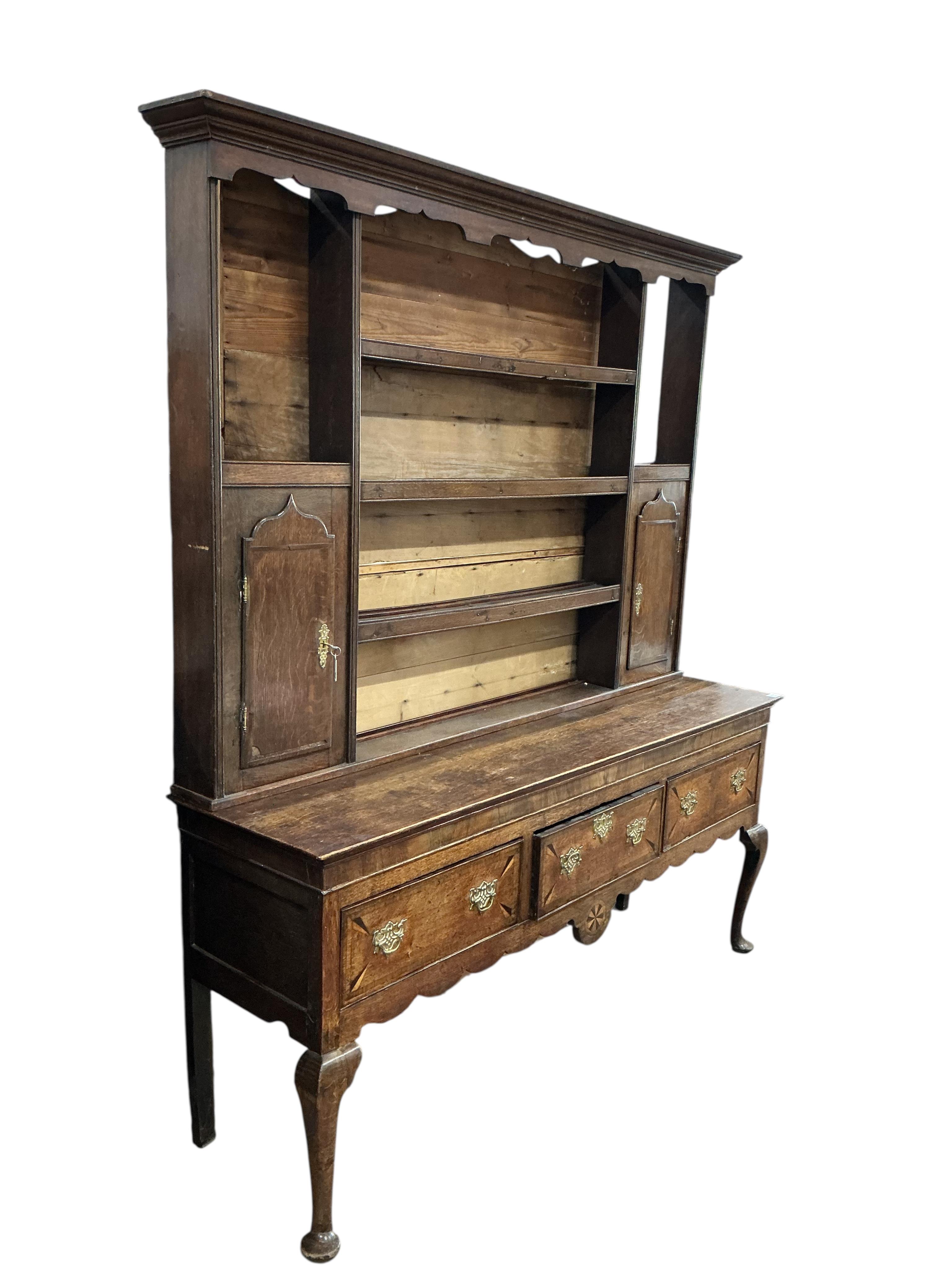 An 18th century inlaid oak dresser, width 183cm, depth 49cm, height 213cm